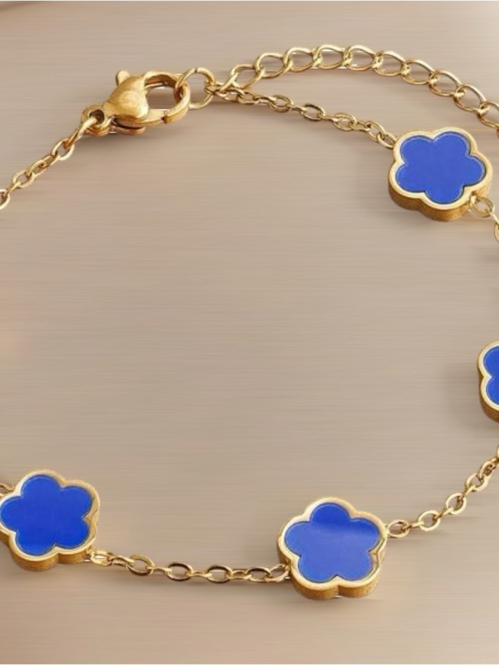 Gold Tone Bracelet with Blue Clover Charms
